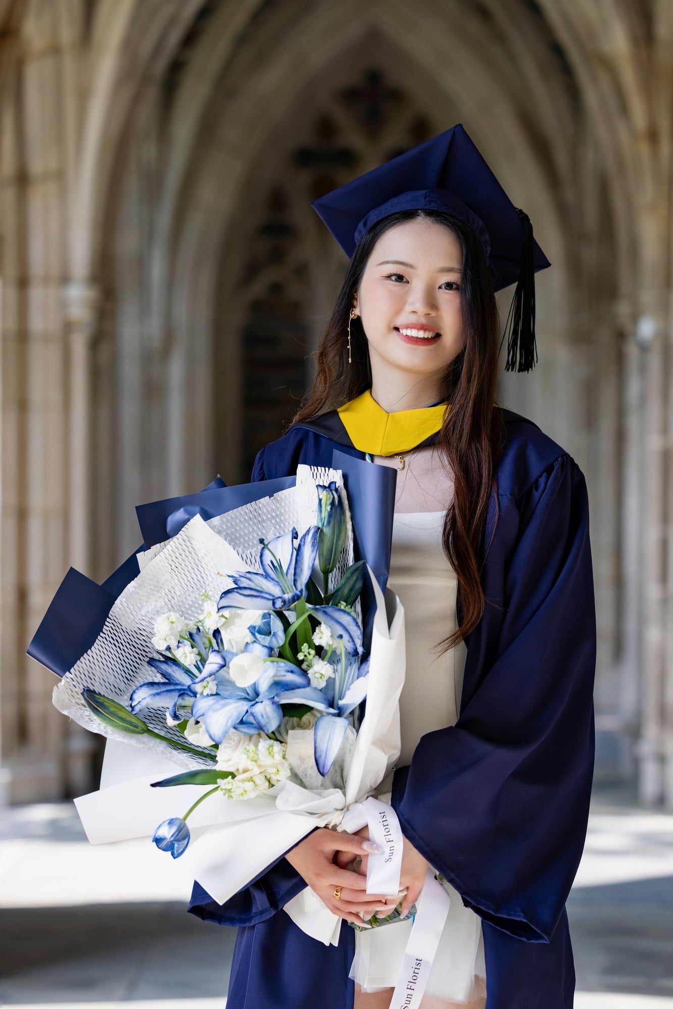 Wrapped in blue and white, this bouquet celebrates both growth and grace. Here’s to the next chapter, as radiant as you are.