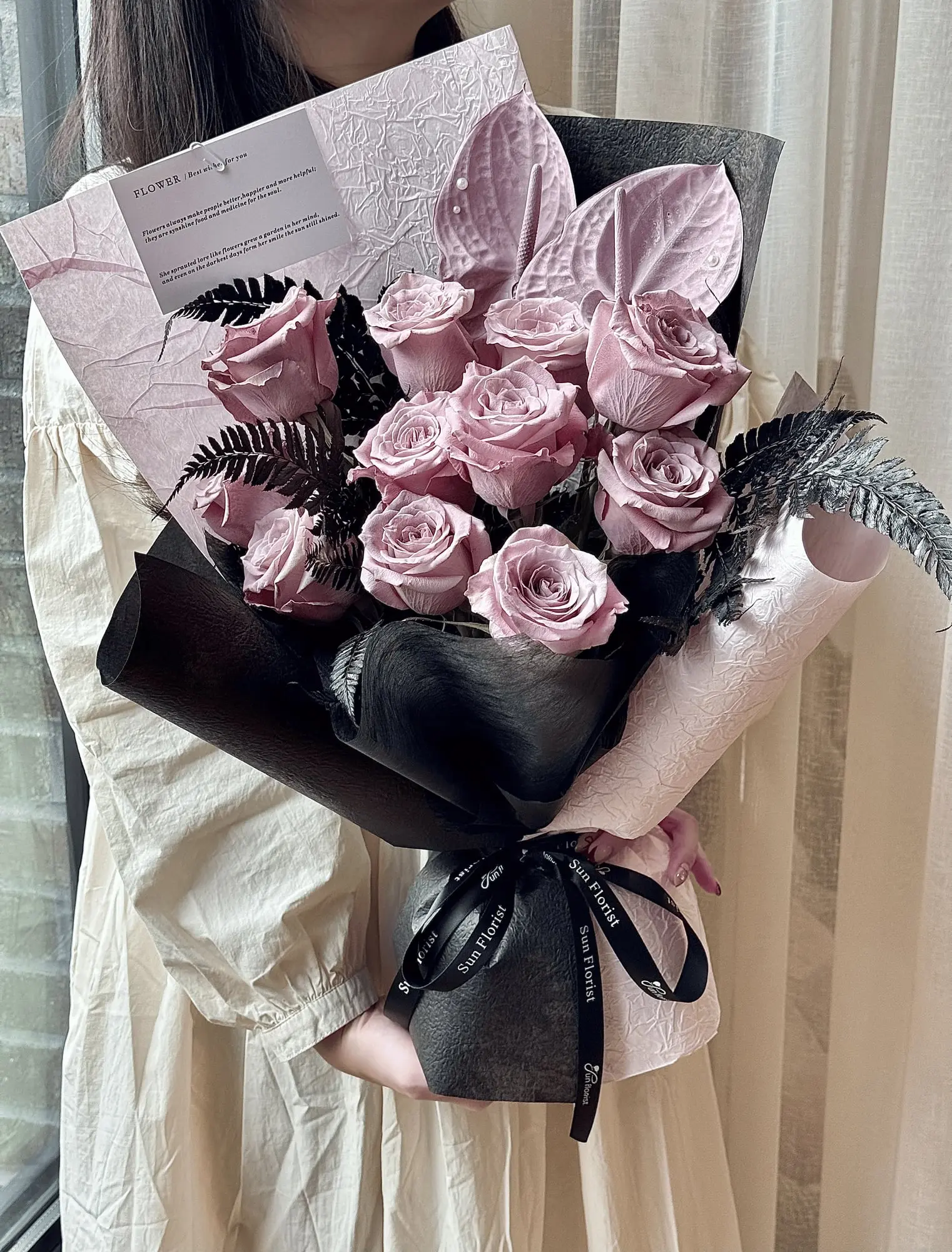 A breathtaking arrangement of soft pink roses, delicate anthuriums, and elegant foliage, this bouquet radiates romance and sophistication.