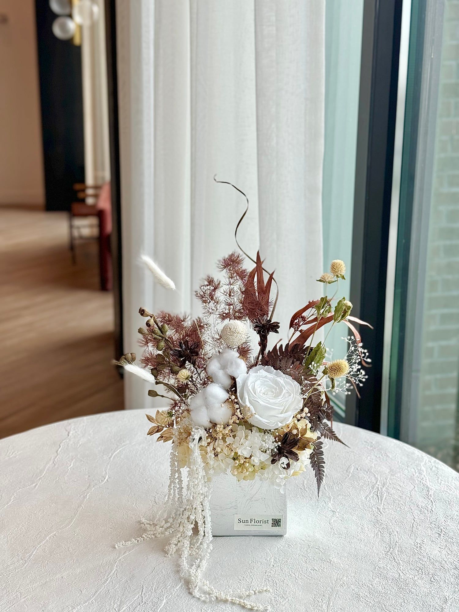 Elevate your space with this exquisitely crafted preserved flower arrangement.