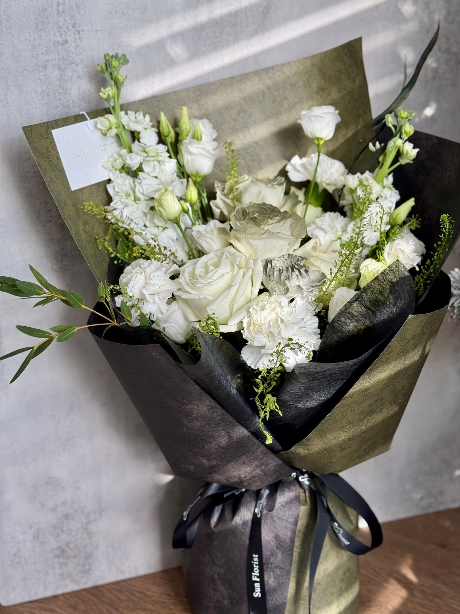 A stunning arrangement of white roses, lisianthus, and delicate blooms , this bouquet embodies purity, elegance, and serenity .